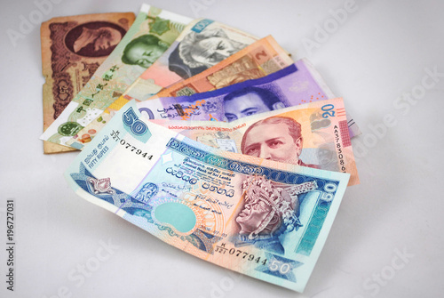 Old and new banknotes of different countries on white background