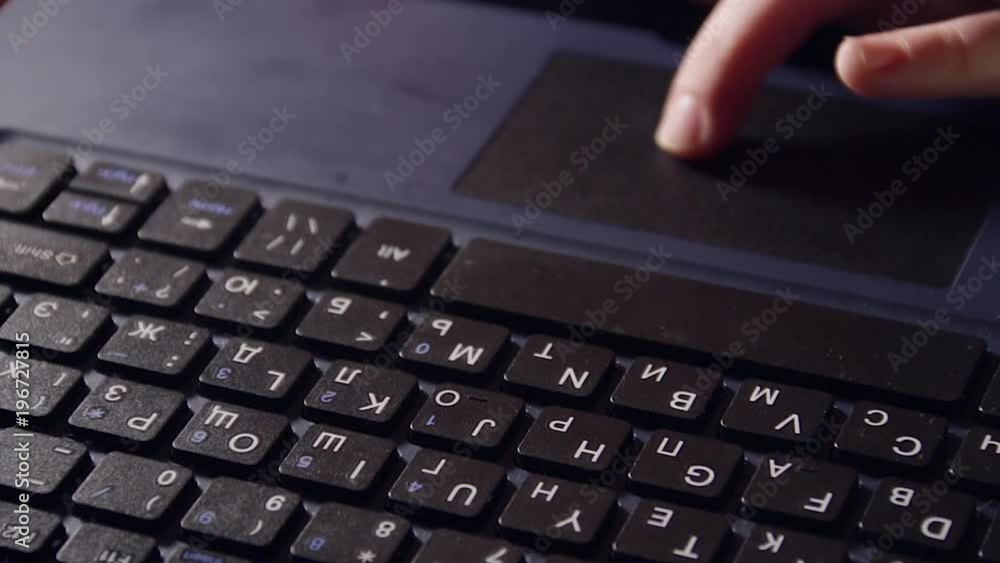 Close up of netbook laptop and a children finger on touchpad.
Close up of netbook laptop and a children finger on touchpad.