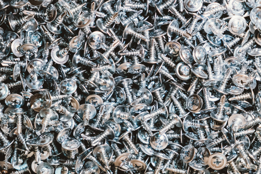 Galvanized screws for construction lie a bunch Galvanized screws for construction lie a bunch