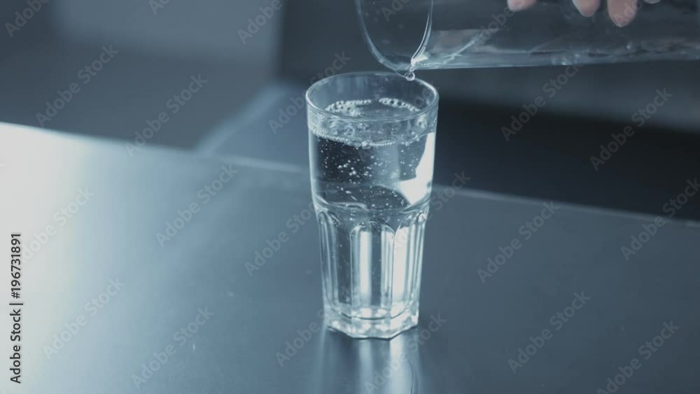 closeup slowmotion of glass fulling with water bubble floating closeup slowmotion of glass fulling with water bubble floating