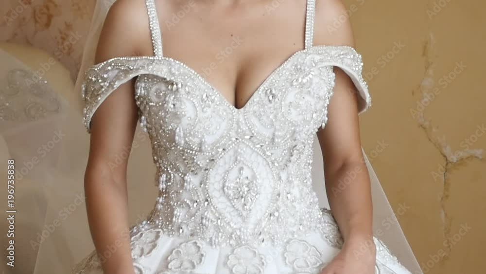 wedding morning, the bride stands in a wedding dress and a long veil and waits for the groom wedding morning, the bride stands in a wedding dress and a long veil and waits for the groom