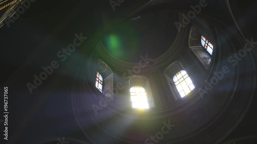 Sun light passes through the stained glass windows of the church