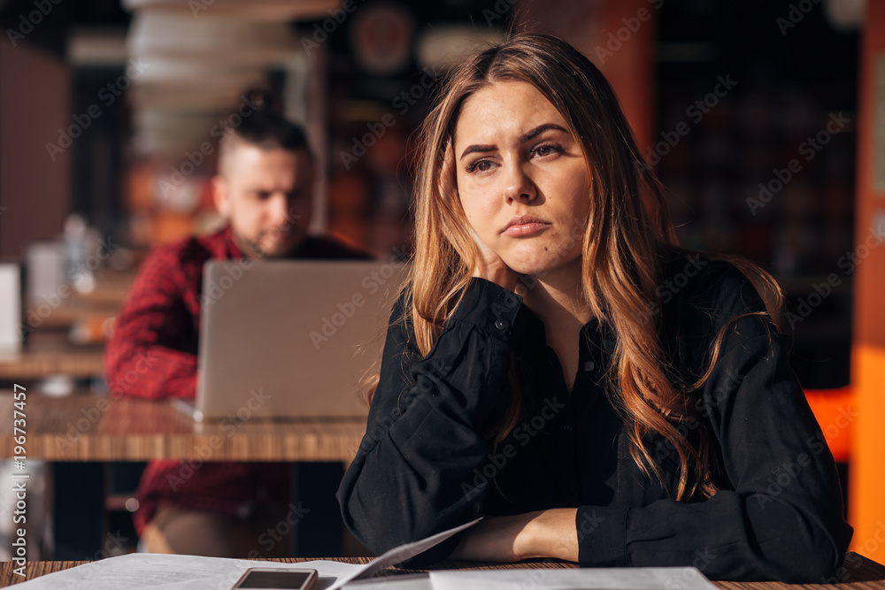tired businesswoman looks sadly at the window in the cafe tired businesswoman looks sadly at the window in the cafe