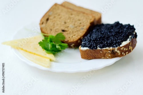 caviar sandwich on a white plate with cheese