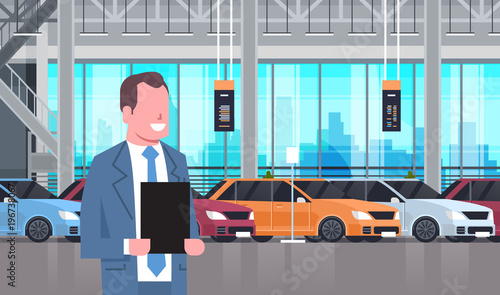 Seller Man In Cars Dealership Center Showroom Interior Over Set Of New Modern Vechicles Flat Vector Illustration