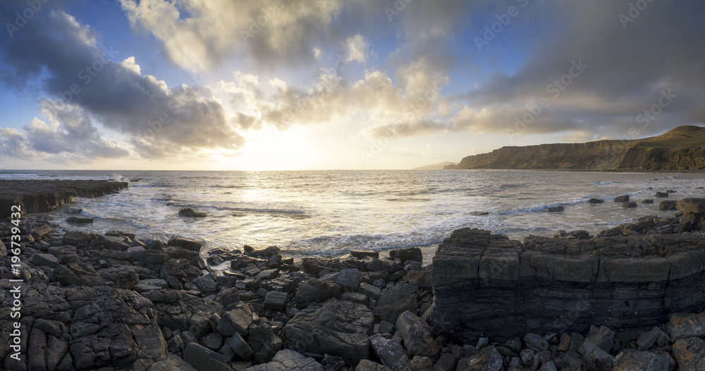 Brandy Bay colorful sunrise panorama landscape in Dorset at low tide