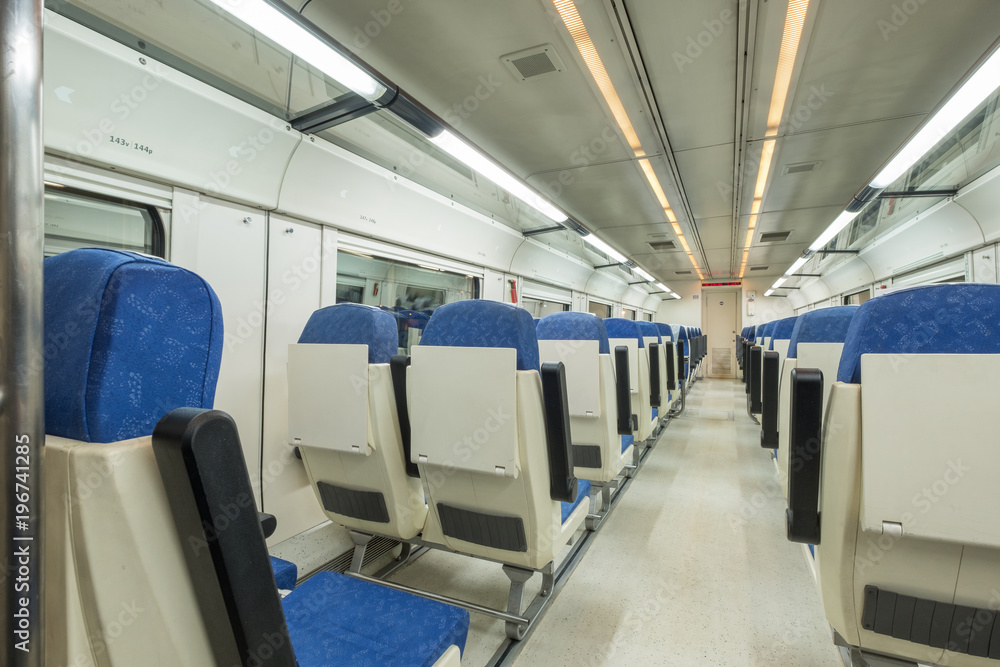 Interior view of a modern empty passenger train car, with no one inside Interior view of a modern empty passenger train car, with no one inside