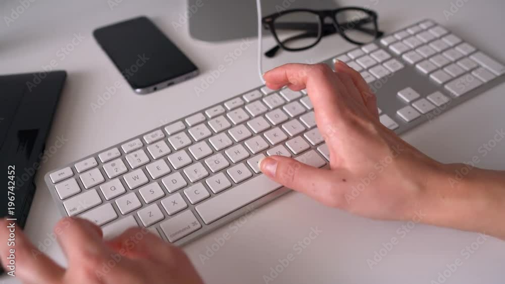 Woman office worker typing on the keyboard Woman office worker typing on the keyboard