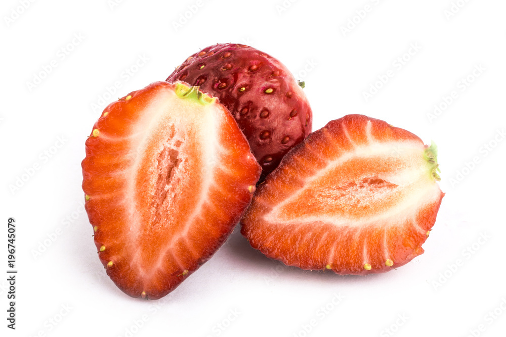 Isolated strawberries. Three fruits, one cut in half on white background Isolated strawberries. Three fruits, one cut in half on white background