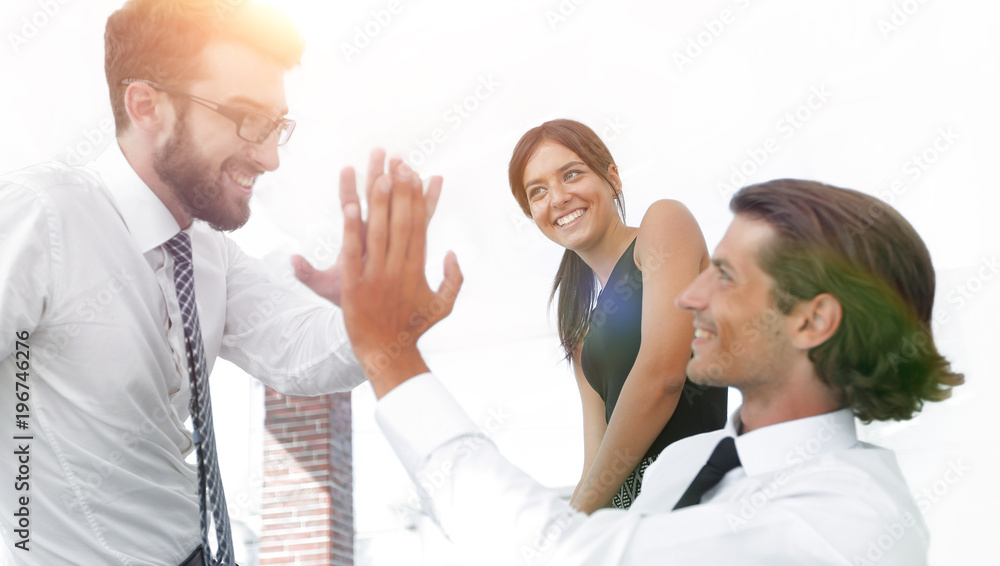 business colleagues giving each other high five. business colleagues giving each other high five.