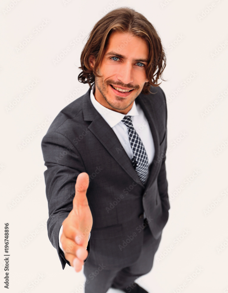 Business man extending hand to shake - focus om hand Business man extending hand to shake - focus om hand