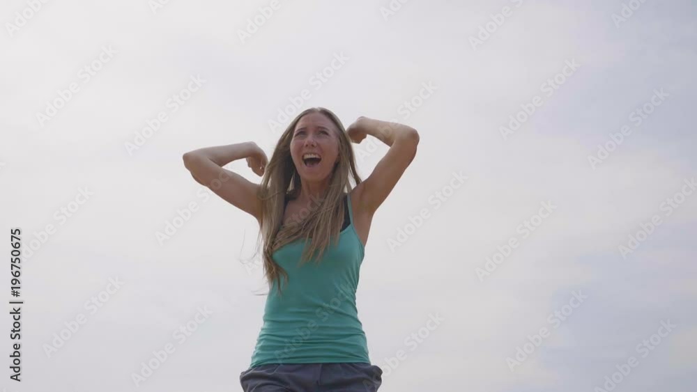 Young happy woman raising hands up and jumping high in the sky. Freedom, happiness,healthy and active lifestyle concept. Young happy woman raising hands up and jumping high in the sky. Freedom, happiness,healthy and active lifestyle concept.