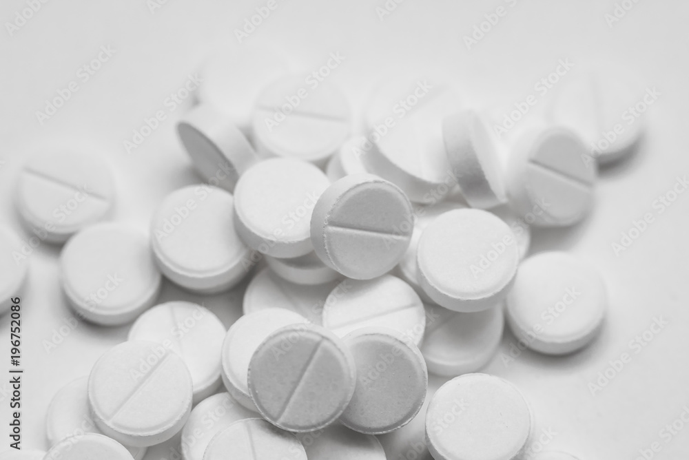 White pills isolated on white background White pills isolated on white background