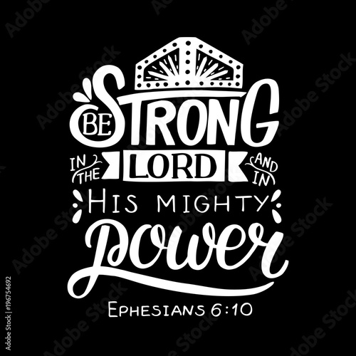 Hand lettering with bible verse Be strong in the Lord and in His mighty power on black background.