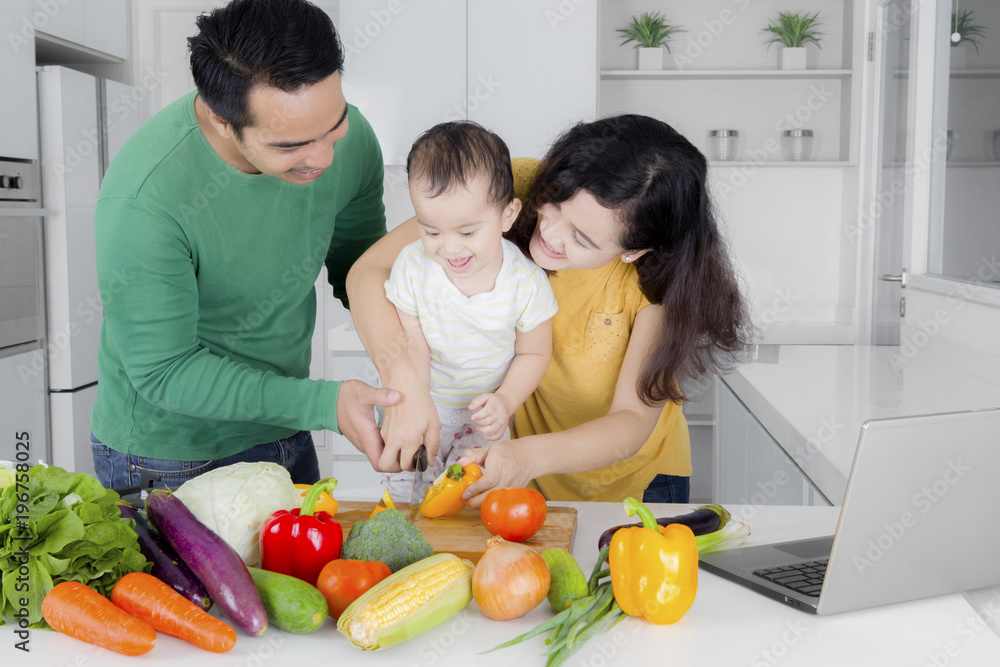 Little girl learns to cook with her parents Little girl learns to cook with her parents