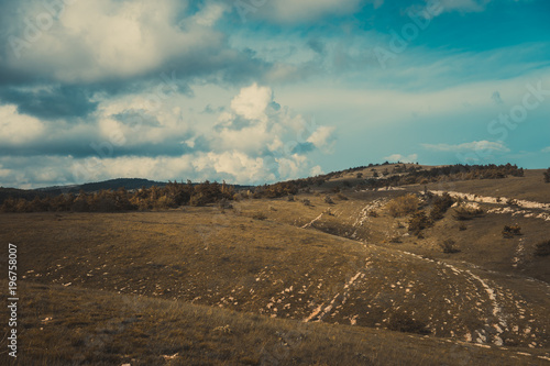 Natural landscape with green hills and vegetation.