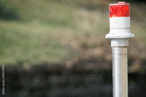 Electric signal lantern on the river water canal, beacon for the boats