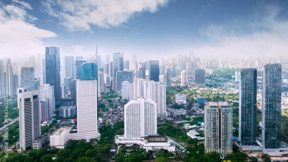 Jakarta downtown cityscape with skyscrapers and apartment buildings under blue sky