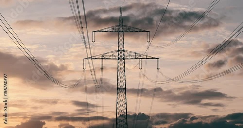 Silhouette of Electric Pylon and Power line in sunset, Time Lapse