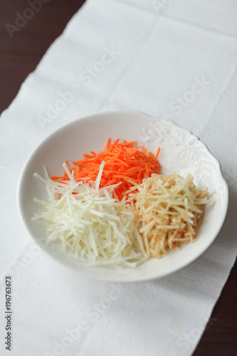 Mix of grated vegetables on white plate