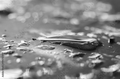 Drops of rain on the tent. Drops closeup lit by the sun. Summer