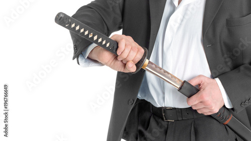 Close-up Of Businessman Removing Sword Over White Background.