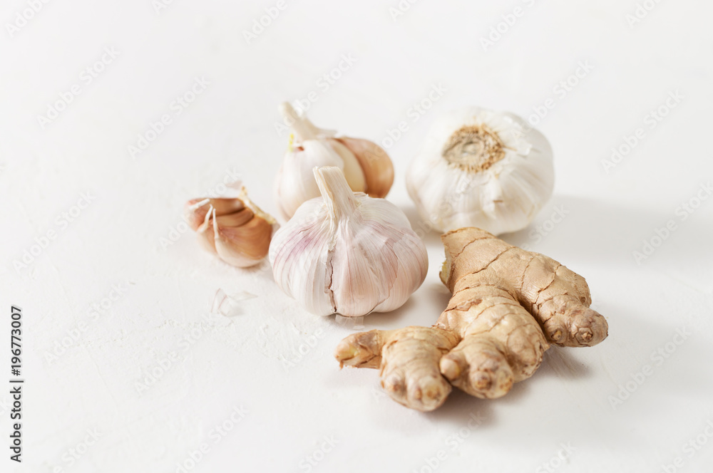 Garlic heads and ginger root on white background Garlic heads and ginger root on white background