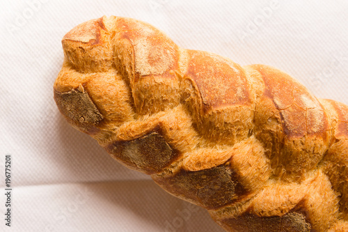 Homemade bread resting on a white cloth with natural light.