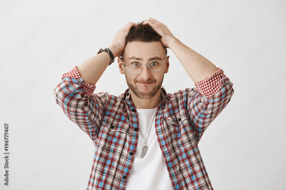 When your are under pressure. Attractive caucasian guy with stylish haircut holding hands on head, sucking lips in and looking with troubled and worried expression, having no clue how to solve riddle When your are under pressure. Attractive caucasian guy with stylish haircut holding hands on head, sucking lips in and looking with troubled and worried expression, having no clue how to solve riddle