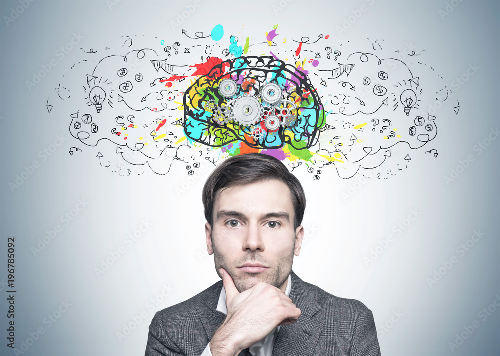 Thoughtful dark haired businessman, cog brain Thoughtful dark haired businessman, cog brain