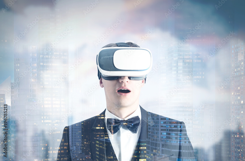 Fototapeta premium Astonished man in VR glasses, gray city