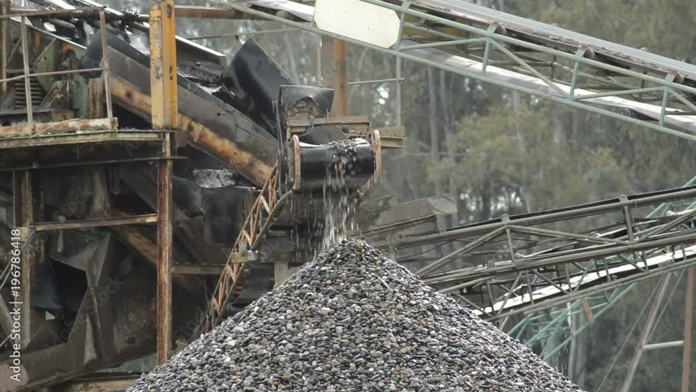 Pebbles conveyor in a sand quarry putting down stones over a pebbles