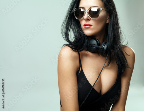 pretty sporty dark hair girl in sunglasses listening to music 