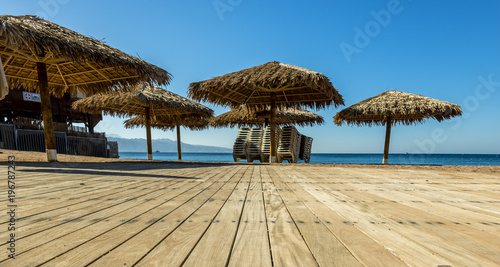 Fototapeta Naklejka Na Ścianę i Meble -  Wooden pleasure terrace on central public beach in Eilat - famous resort in Israel and Middle East. Concept of happy vacation
