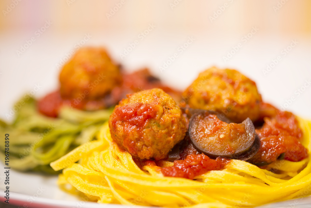 Pasta with meatballs, tomatoes and eggplant