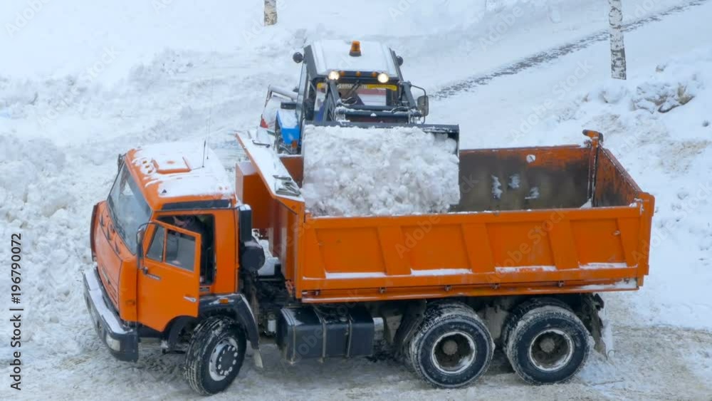 Utility service. Clear the road from the snow after a heavy snowfall. Tractor and dumper. Utility service. Clear the road from the snow after a heavy snowfall. Tractor and dumper.