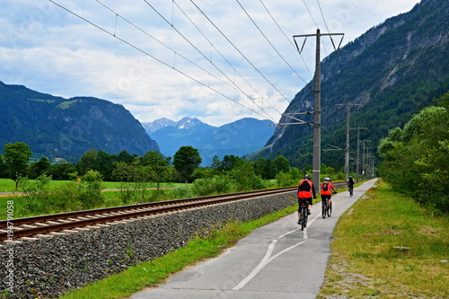 Austrian Alps - cyclists on the cycle path along the river Draw
