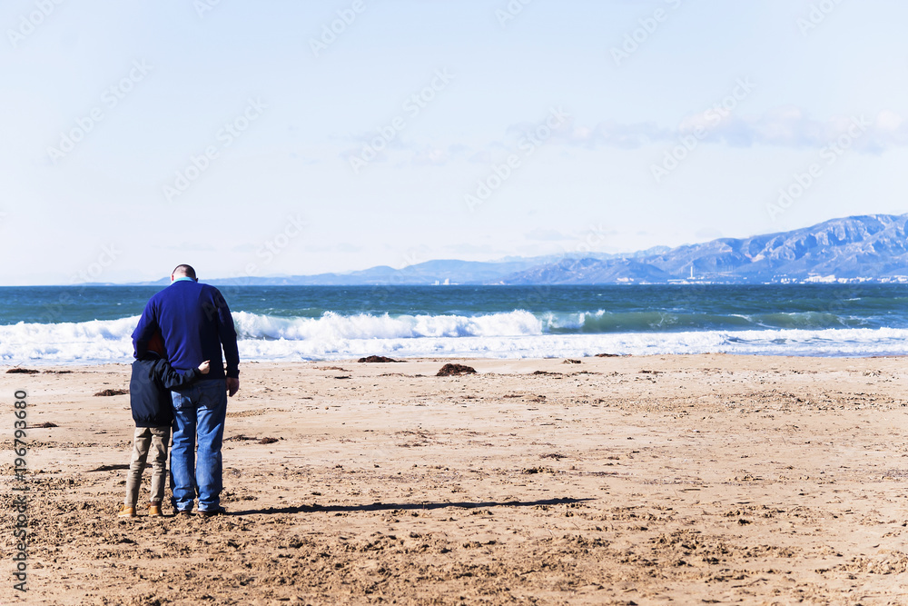 family father and son on the beach view