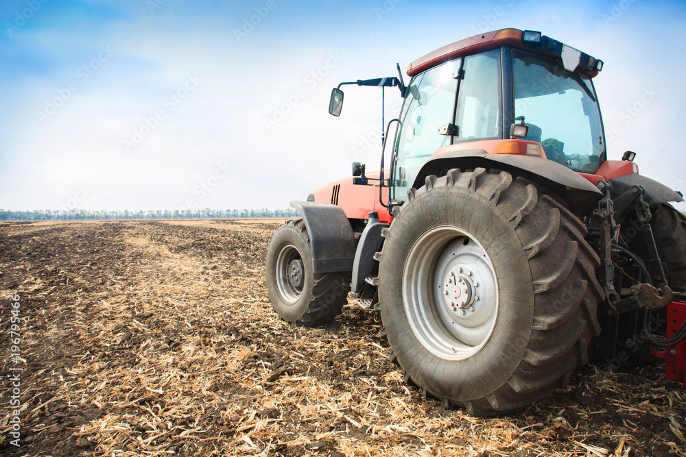 Modern red tractor in the field. Modern red tractor in the field.