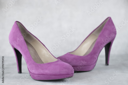 Rose velvet shoes heels on gray background.
