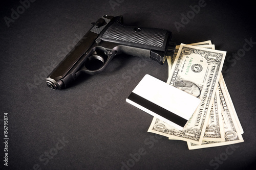 Close up money with Gun on black background. photo