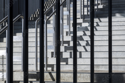 Composition with geometric structure of steps and metal balustrade.