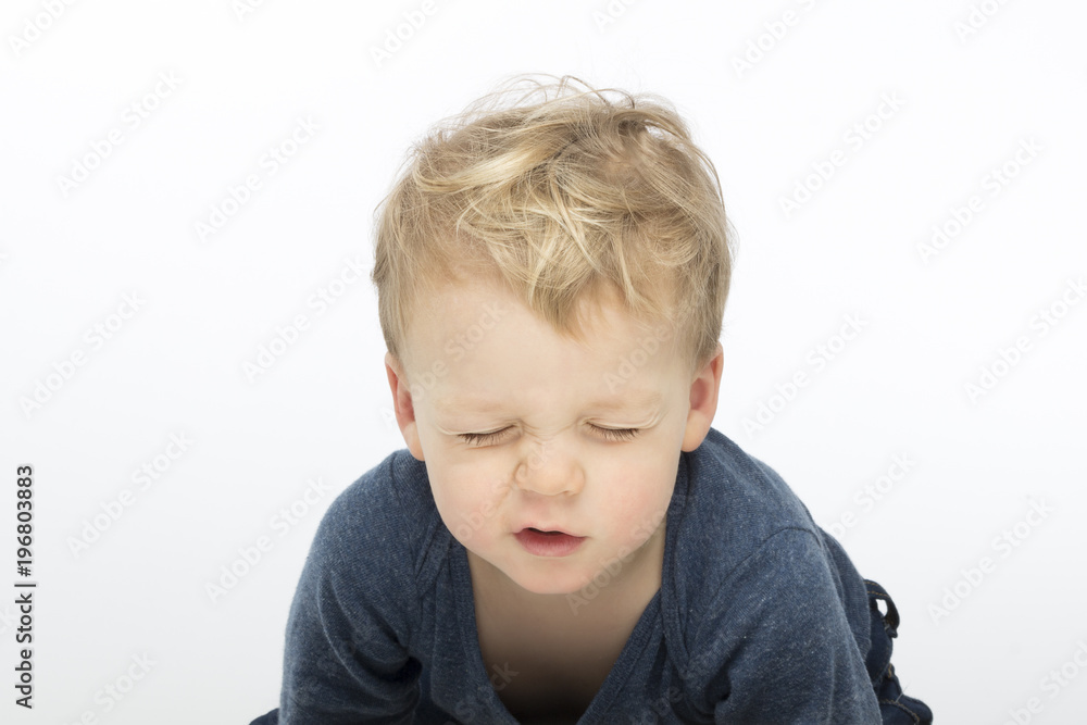 screwed-up toddler on white background. Studio shot screwed-up toddler on white background. Studio shot