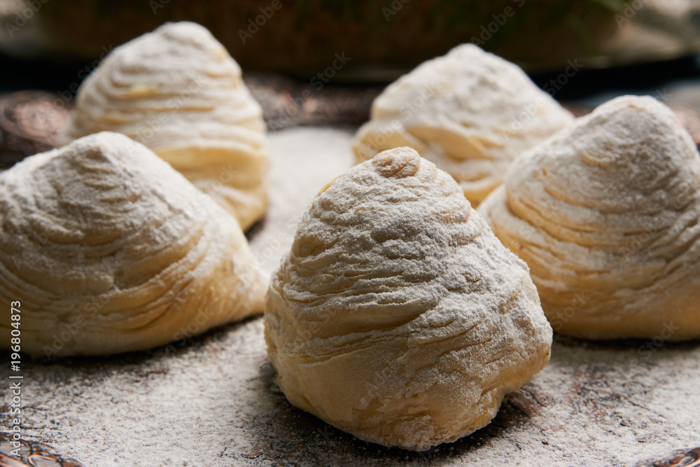 Fototapeta premium Badambura powdered pastry on Novruz tray. Azerbaijan traditional pastry cookie badambura on rustic table background