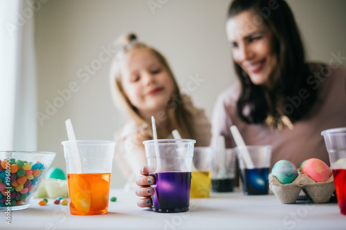 Mother and Daughter Painting Easter Eggs together