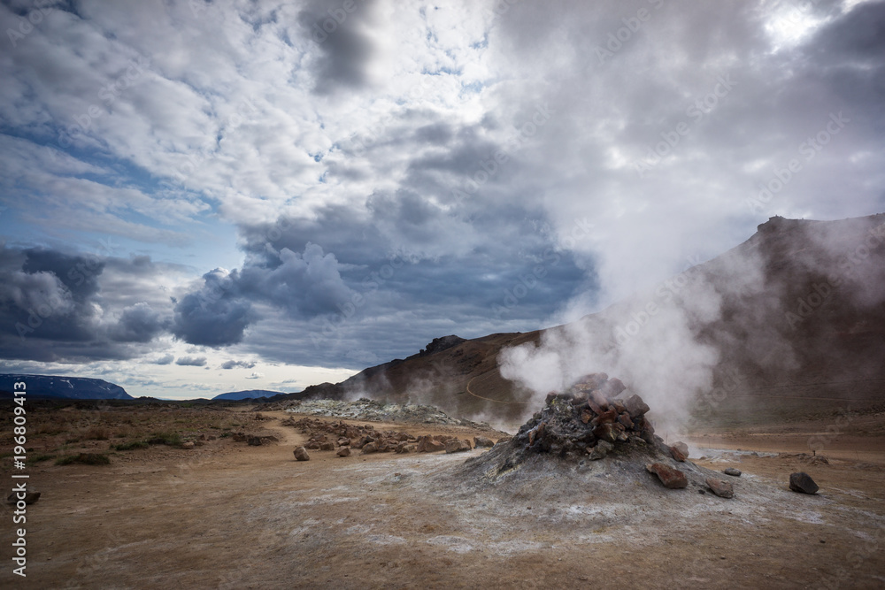 Hissing chimney in large geothermal field of Hverir during a cloudy day in Iceland