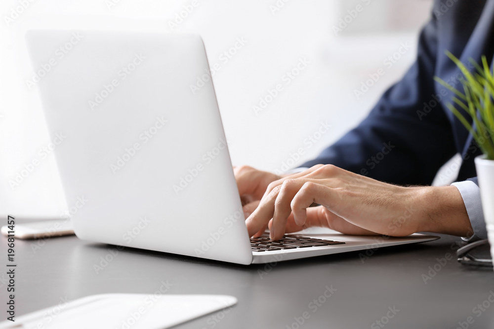 Man working with laptop at table Man working with laptop at table