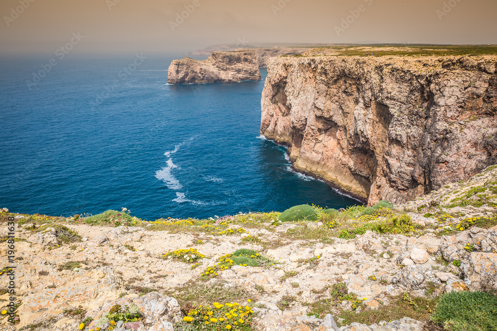 High cliffs and blue ocean at Cabo Sao Vicente on coast of Portugal