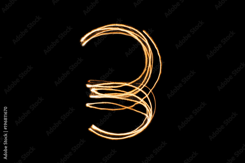 Orange light painting three number on black background . Orange light painting three number on black background .