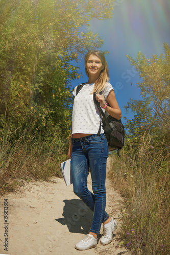 Happy young woman traweling to the mountains. (Travel, nature, adventure, victory concept)
